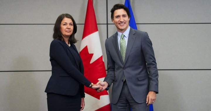 Premier Danielle Smith greets Prime Minister Trudeau with awkward handshake, grimace