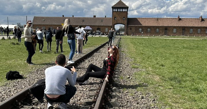 Tourists spark outrage after posing for photos on Auschwitz train tracks – National